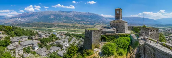 Gjirokastër, Albania, with its historic stone rooftops and fortress overlooking the mountain valley.