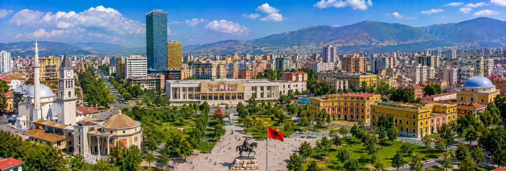 Tirana panoramic view with Skanderbeg Square, historic landmarks, modern skyline and mountains