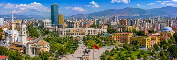 Tirana panoramic view with Skanderbeg Square, historic landmarks, modern skyline and mountains