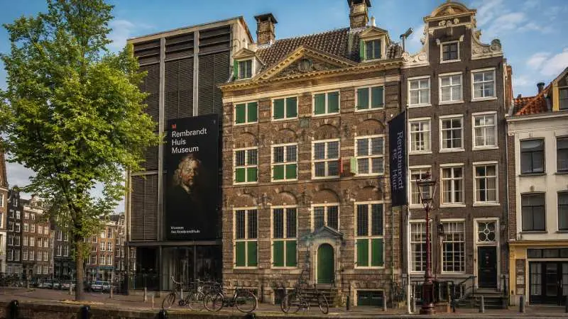 Rembrandt House Museum in Amsterdam’s historic center with bicycles and traditional Dutch buildings
