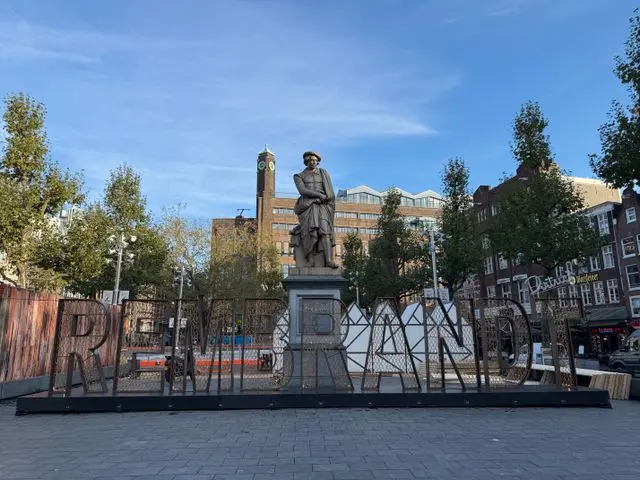 Rembrandt statue and historic buildings in Amsterdam’s city center