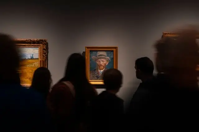 Visitors viewing Vincent van Gogh's famous self-portrait inside the Van Gogh Museum in Amsterdam.