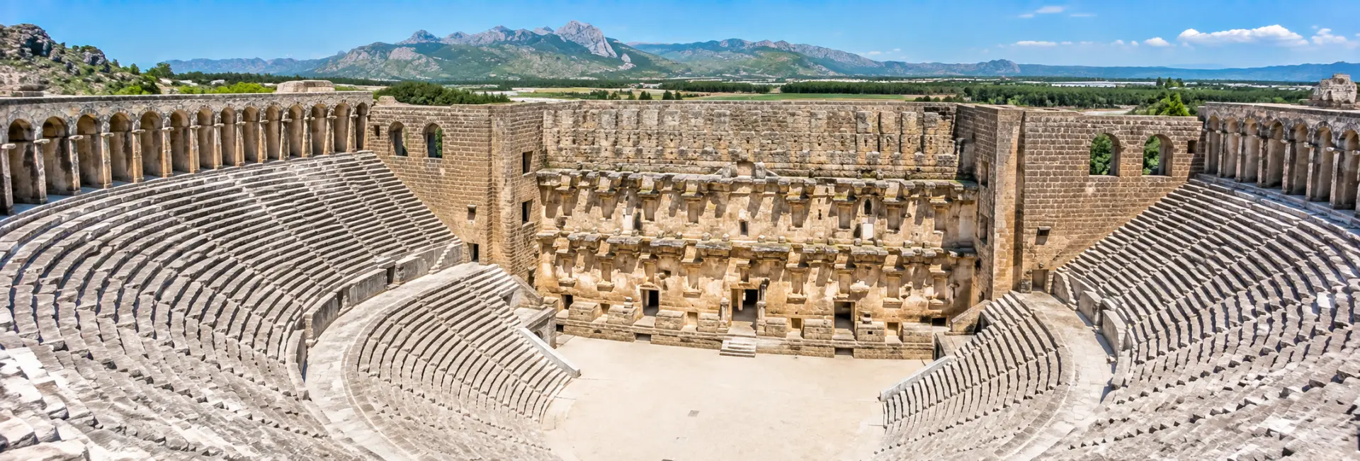Aspendos Ancient Theatre in Antalya, Türkiye, showcasing its grand Roman amphitheatre and mountain backdrop