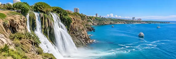 Düden Waterfalls in Antalya, Türkiye, surrounded by lush greenery and rugged rocks