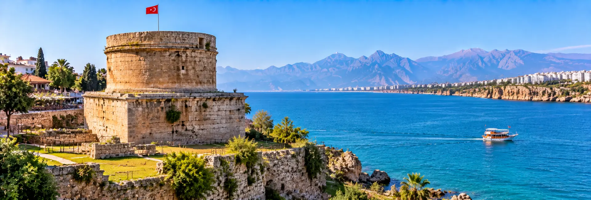 Hıdırlık Tower in Antalya, Türkiye, overlooking the turquoise Mediterranean Sea and Taurus Mountains