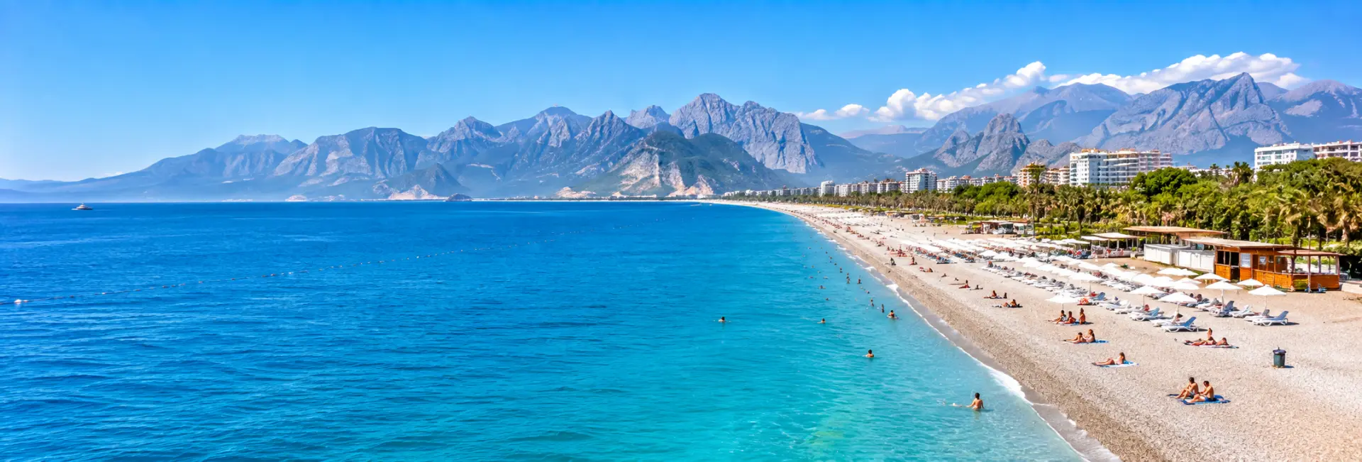 Konyaaltı Beach in Antalya, Türkiye, with turquoise waters and dramatic mountain views