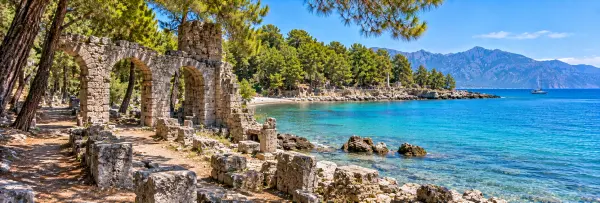 Phaselis Ancient City in Antalya, Türkiye, with ancient ruins beside the turquoise Mediterranean Sea