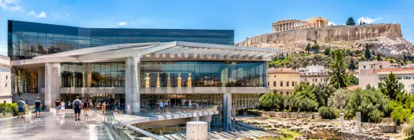 Acropolis Museum in Athens, Greece, with the Parthenon visible on the hill behind.
