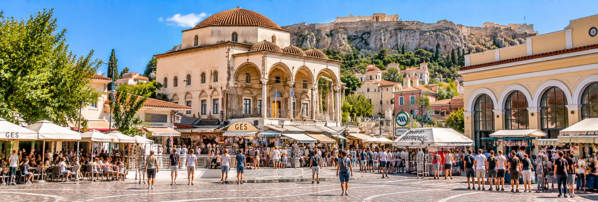 Monastiraki Square in Athens, Greece, with market stalls, historic buildings, and the Acropolis