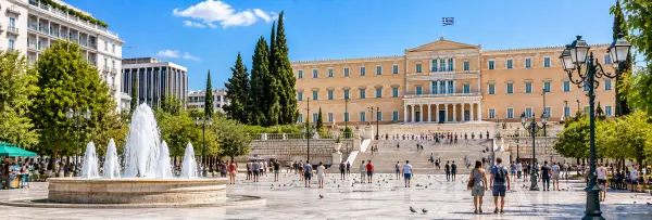Syntagma Square in Athens, Greece, with the Hellenic Parliament, fountain, and surrounding greenery