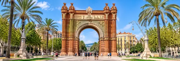 Arc de Triomf in Barcelona with palm trees and the Passeig de Lluís Companys promenade