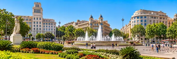 Plaça de Catalunya in Barcelona, Spain, with its fountain, gardens, sculptures and surrounding city buildings