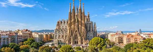 Sagrada Família in Barcelona, Spain, surrounded by the cityscape under a clear blue sky