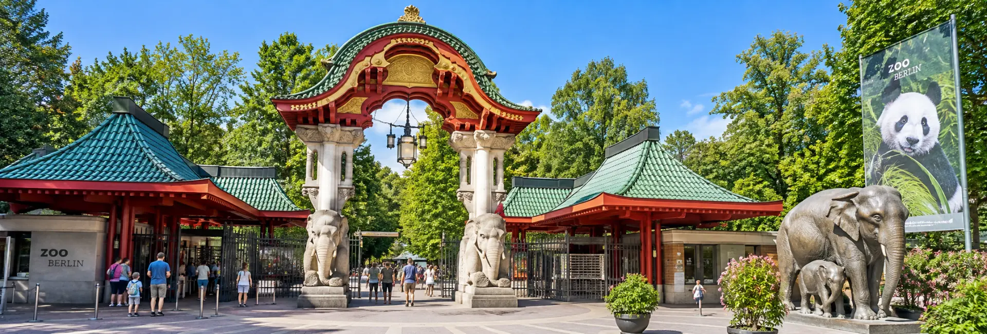 Berlin Zoo entrance with ornate gateway, elephant sculptures and lush greenery