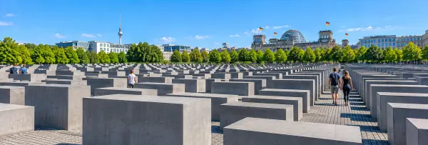 Holocaust Memorial in Berlin with rows of concrete stelae under a clear blue sky