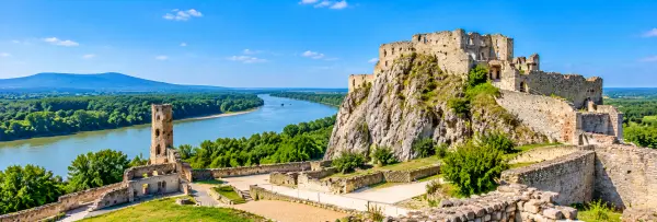 Devin Castle ruins overlooking the Danube River, surrounded by green hills near Bratislava, Slovakia.