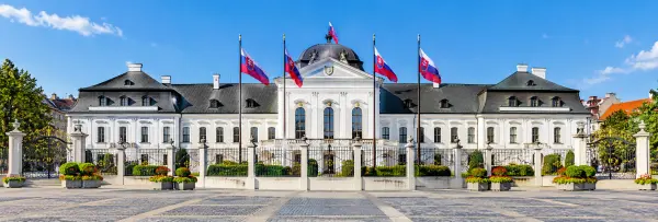 Grassalkovich Palace in Bratislava, Slovakia, featuring its elegant Baroque architecture and Slovak flags.