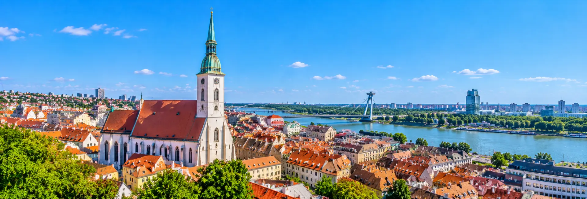 Panoramic view of St. Martin’s Cathedral with its Gothic spire overlooking Bratislava Old Town and the Danube River.
