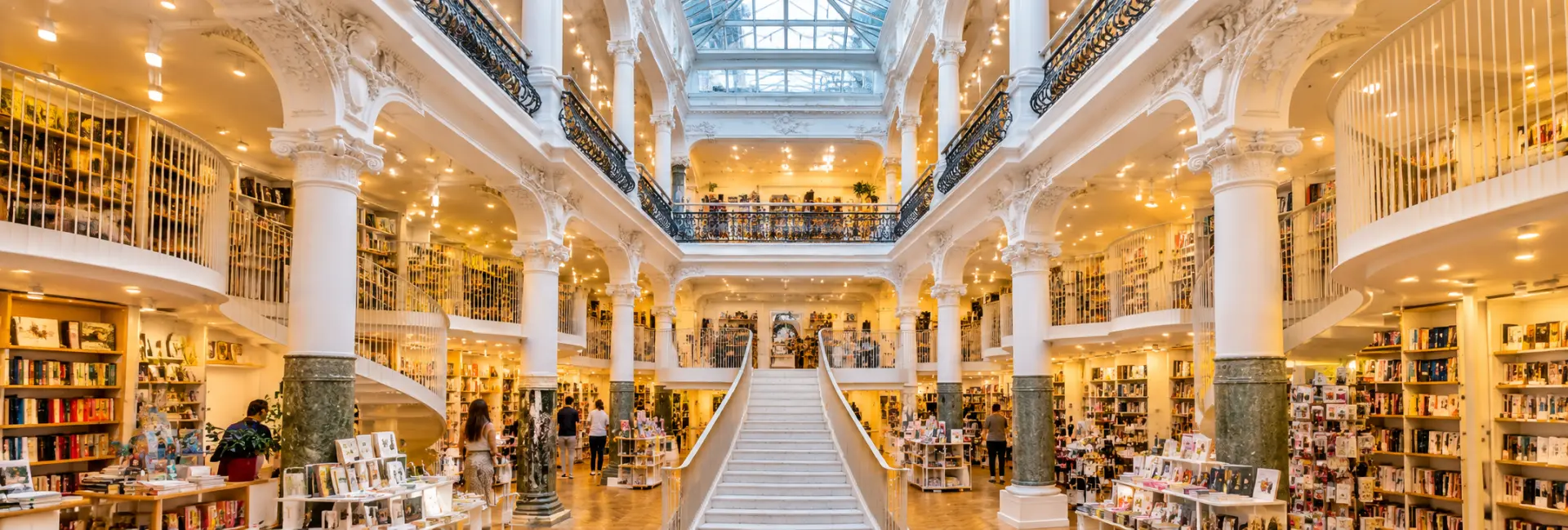 Cărturești Carusel bookstore in Bucharest, Romania, featuring elegant white staircases, balconies and bookshelves.