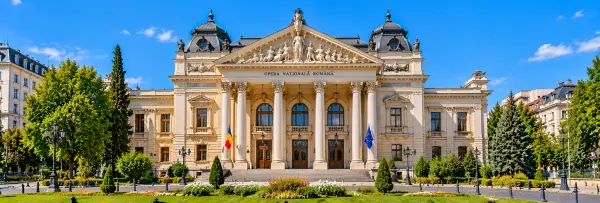 Romanian National Opera in Bucharest, Romania, featuring its grand facade, classical columns and landscaped gardens.
