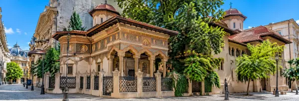 Stavropoleos Monastery in Bucharest, Romania, featuring ornate frescoes, carved stone columns, and historic architecture