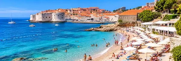 Banje Beach in Dubrovnik, Croatia, with turquoise Adriatic waters and views of the historic Old Town.