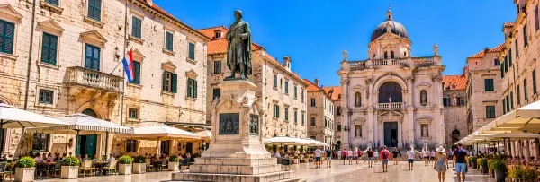 Gundulić Square in Dubrovnik, Croatia, featuring the Ivan Gundulić Monument and historic Old Town buildings.