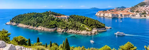 Lokrum Island near Dubrovnik, Croatia, with lush greenery, rocky shores and the blue Adriatic Sea.