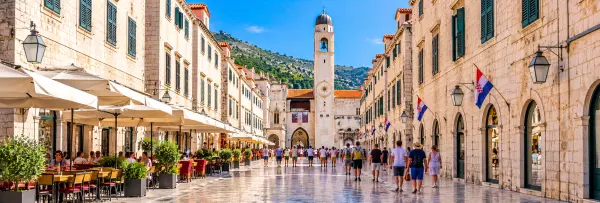 Stradun in Dubrovnik Old Town, Croatia, lined with historic stone buildings, cafés and landmarks.
