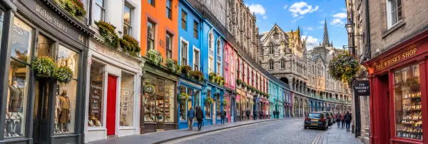 Victoria Street in Edinburgh with colorful historic buildings, shops and cobbled streets