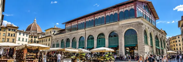 Mercato Centrale in Florence, Italy, with the historic market hall and Florence Cathedral dome