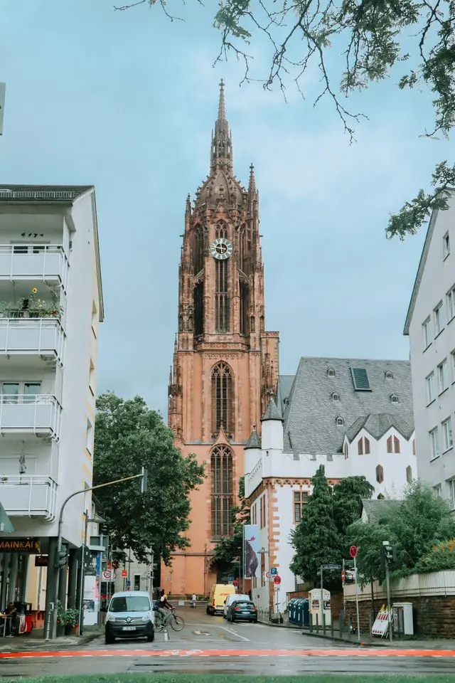 Frankfurt Cathedral tower rising above a city street in central Frankfurt, Germany