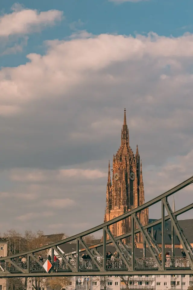 Frankfurt Cathedral rising behind the Eiserner Steg pedestrian bridge in Frankfurt, Germany