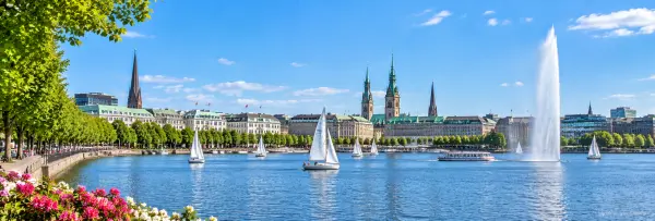 Alster Lakes in Hamburg, Germany with sailboats, waterfront buildings and the Alster fountain