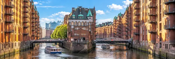 Speicherstadt in Hamburg, Germany with red-brick warehouses, canals, bridges and boats