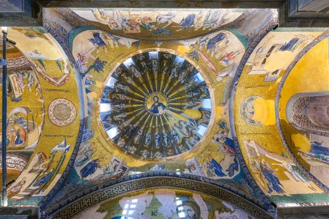Ornate Byzantine mosaics and religious artwork covering the dome and arches inside Chora Church.