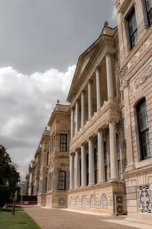 Ornate exterior of Dolmabahçe Palace showing its grand columns, carved stonework, and elegant façade.