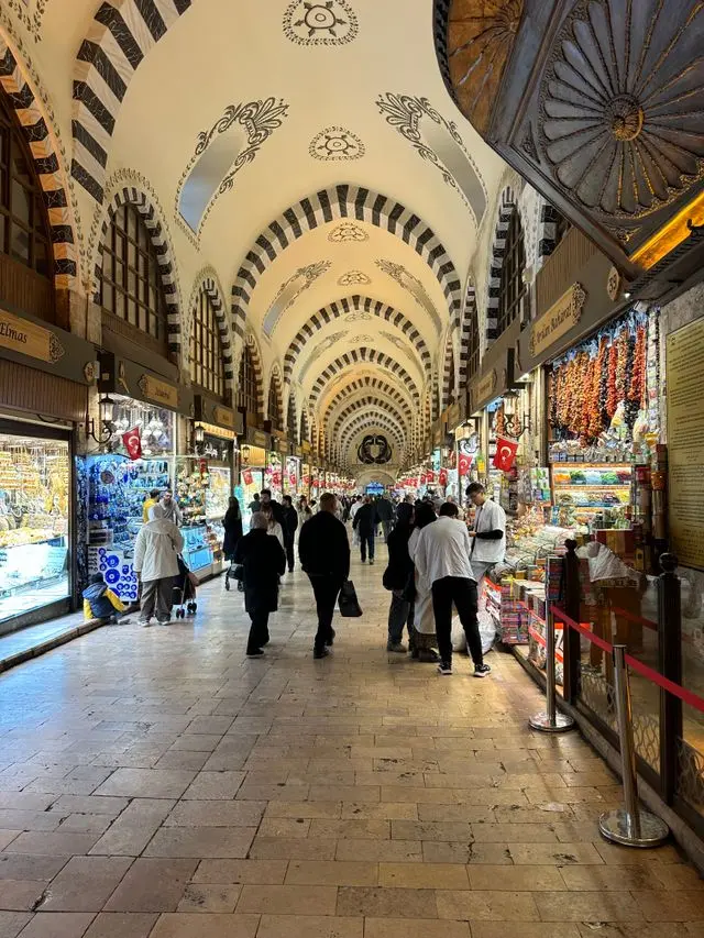 Bustling interior of Istanbul’s Grand Bazaar with ornate arches and colorful shops.