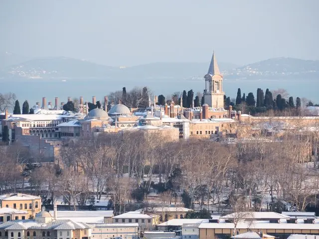 Topkapi Palace complex in Istanbul viewed from above with the Bosphorus and surrounding hills.