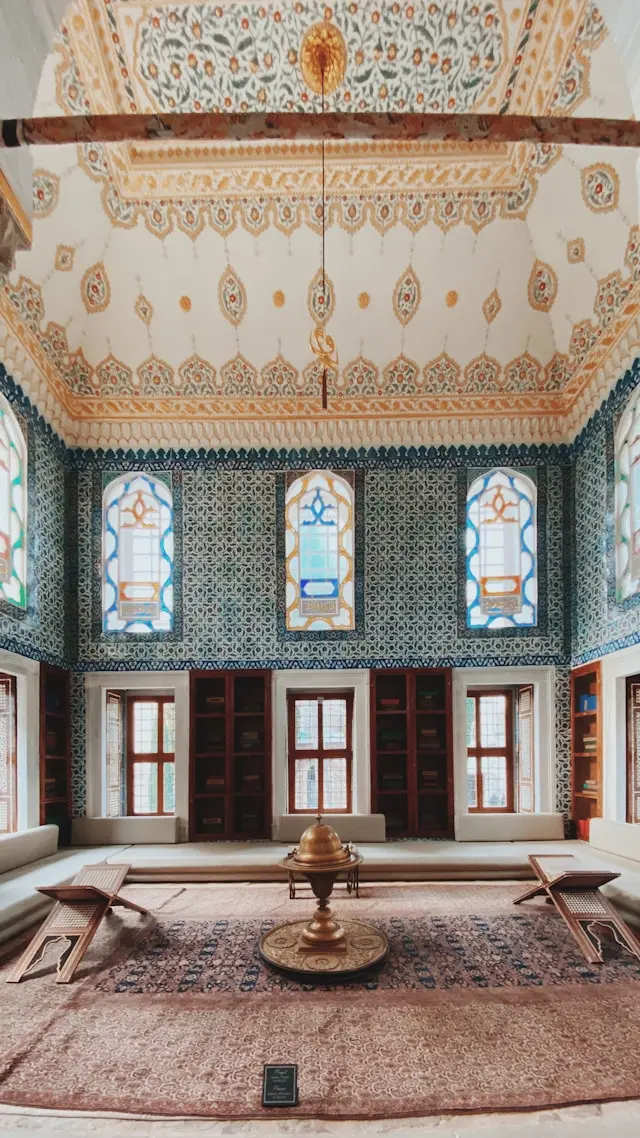 Ornate tiled interior room at Topkapi Palace in Istanbul with colorful windows and Ottoman décor.