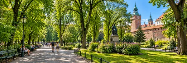 Planty Park in Kraków, Poland, with leafy pathways, gardens and historic Wawel architecture