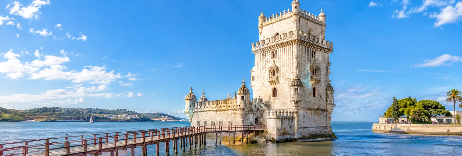 Belém Tower in Lisbon, Portugal, overlooking the Tagus River on a bright sunny day.
