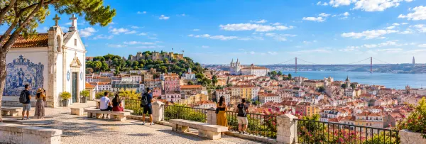 Miradouro da Senhora do Monte in Lisbon, Portugal, overlooking São Jorge Castle, the Tagus, and Lisbon rooftops.