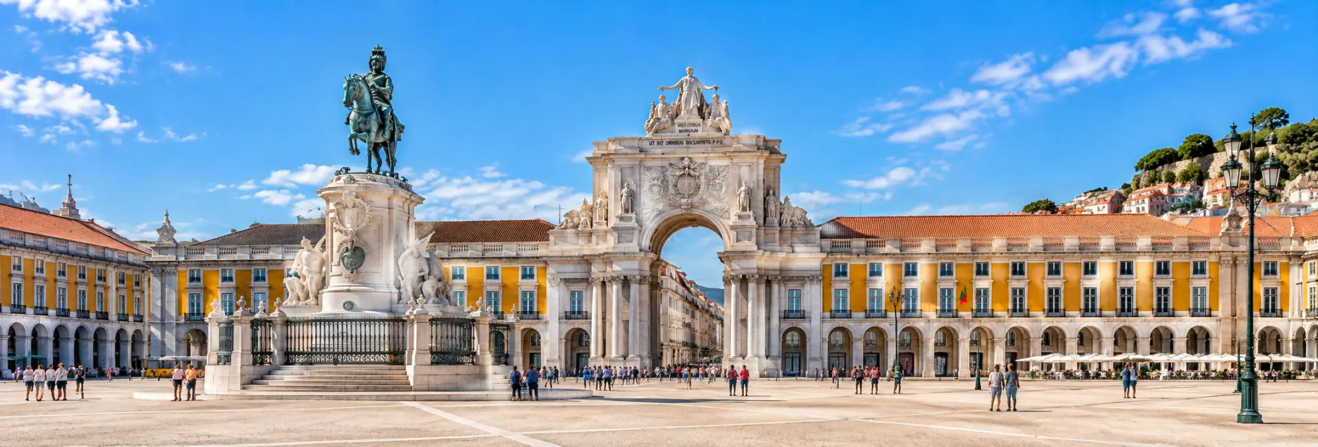 Praça do Comércio in Lisbon, Portugal, with its grand yellow arcades, triumphal arch, and equestrian statue.