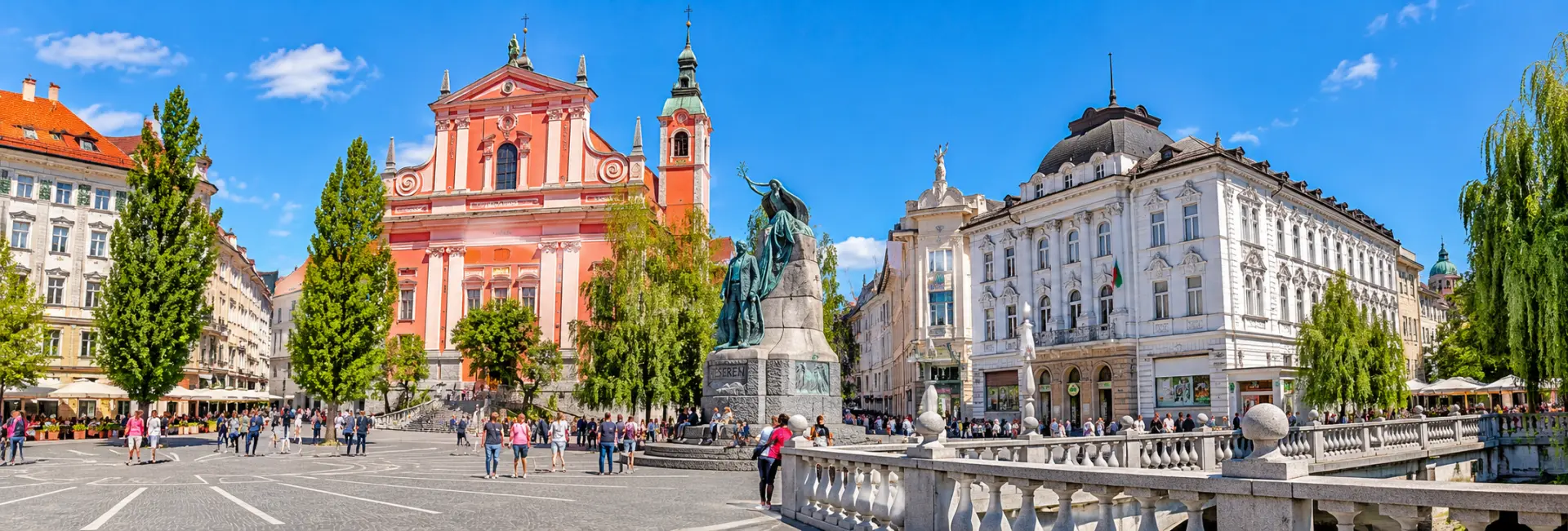 Prešeren Square in Ljubljana featuring the Franciscan Church, Prešeren Monument and historic architecture.