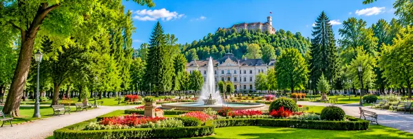Tivoli Park in Ljubljana, Slovenia, featuring lush green gardens, colorful flowerbeds, walking paths and a fountain.