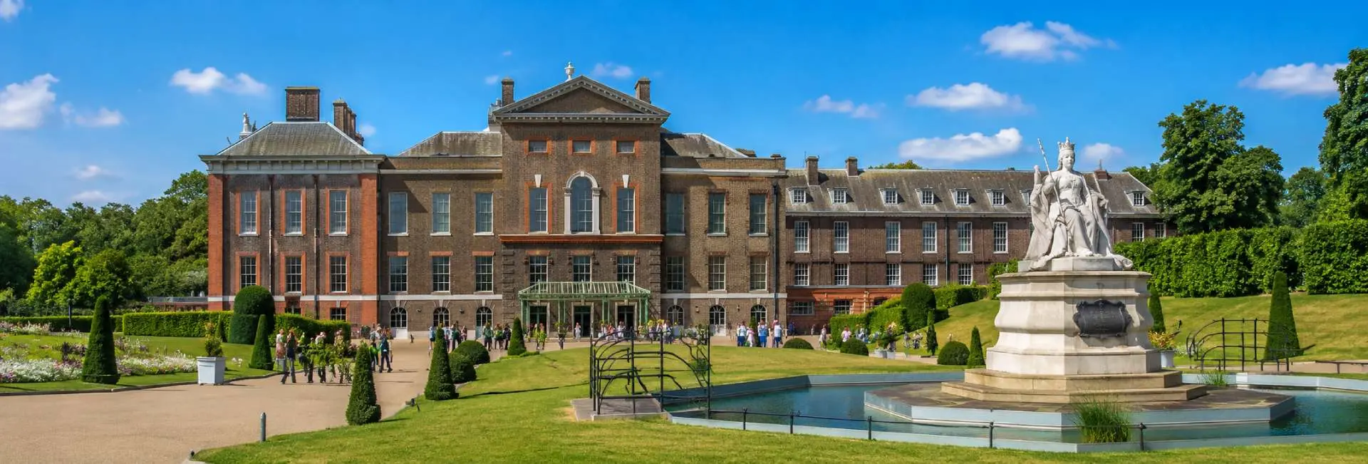 Kensington Palace in London with its historic red-brick façade and landscaped gardens