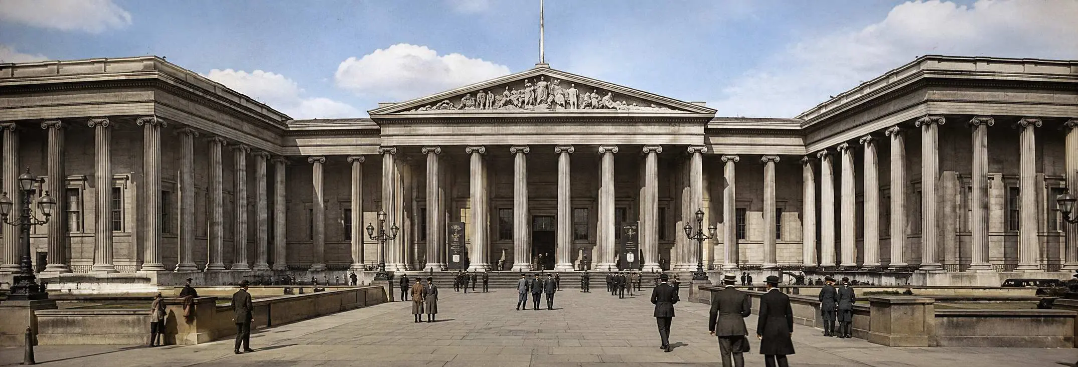Front view of the British Museum in London with its iconic neoclassical columns and grand entrance on a clear daytime sc