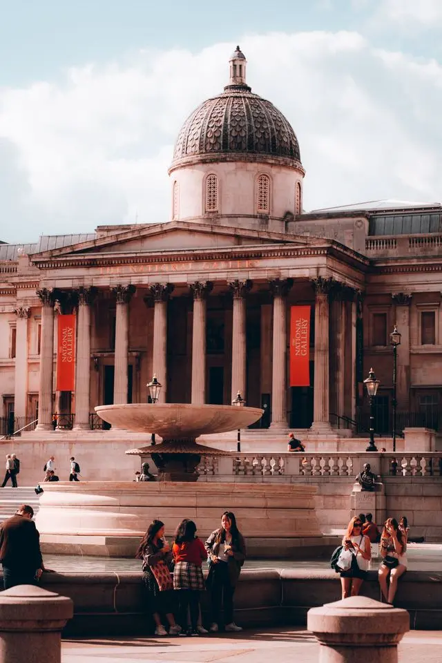 National Gallery with grand columns, dome, fountain and visitors
