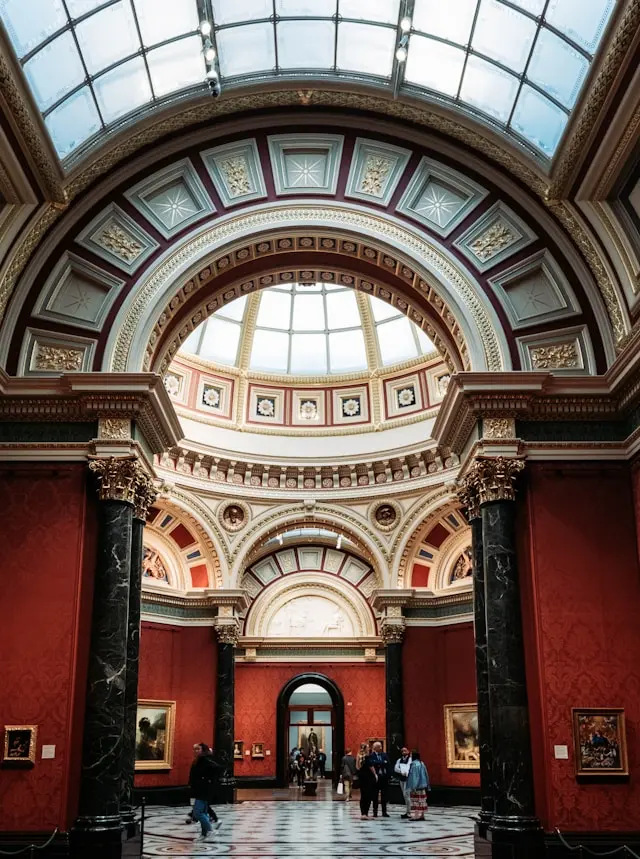 Ornate interior of the National Gallery with arches and a glass-domed ceiling